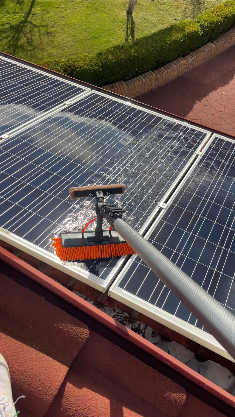 Water-fed brush cleaning a rooftop solar panel, Greater Hobart