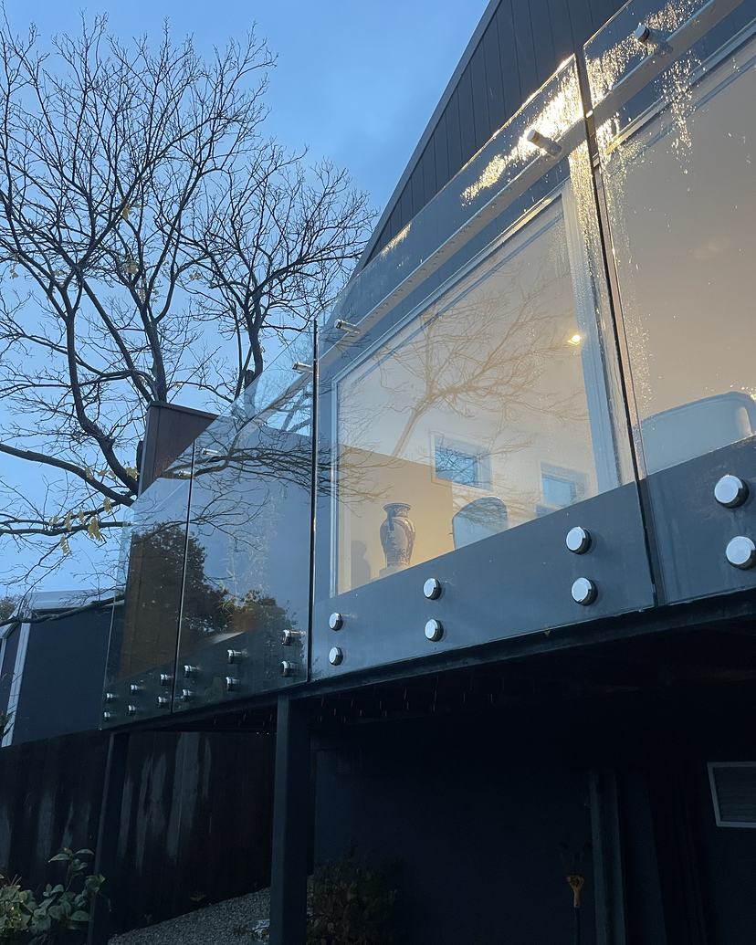 Frameless glass balustrade cleaned streak-free at dusk