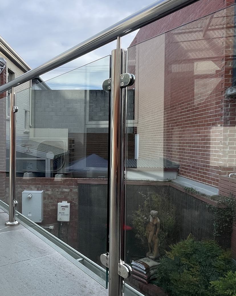 Glass balustrade with stainless steel posts, cleaned streak-free