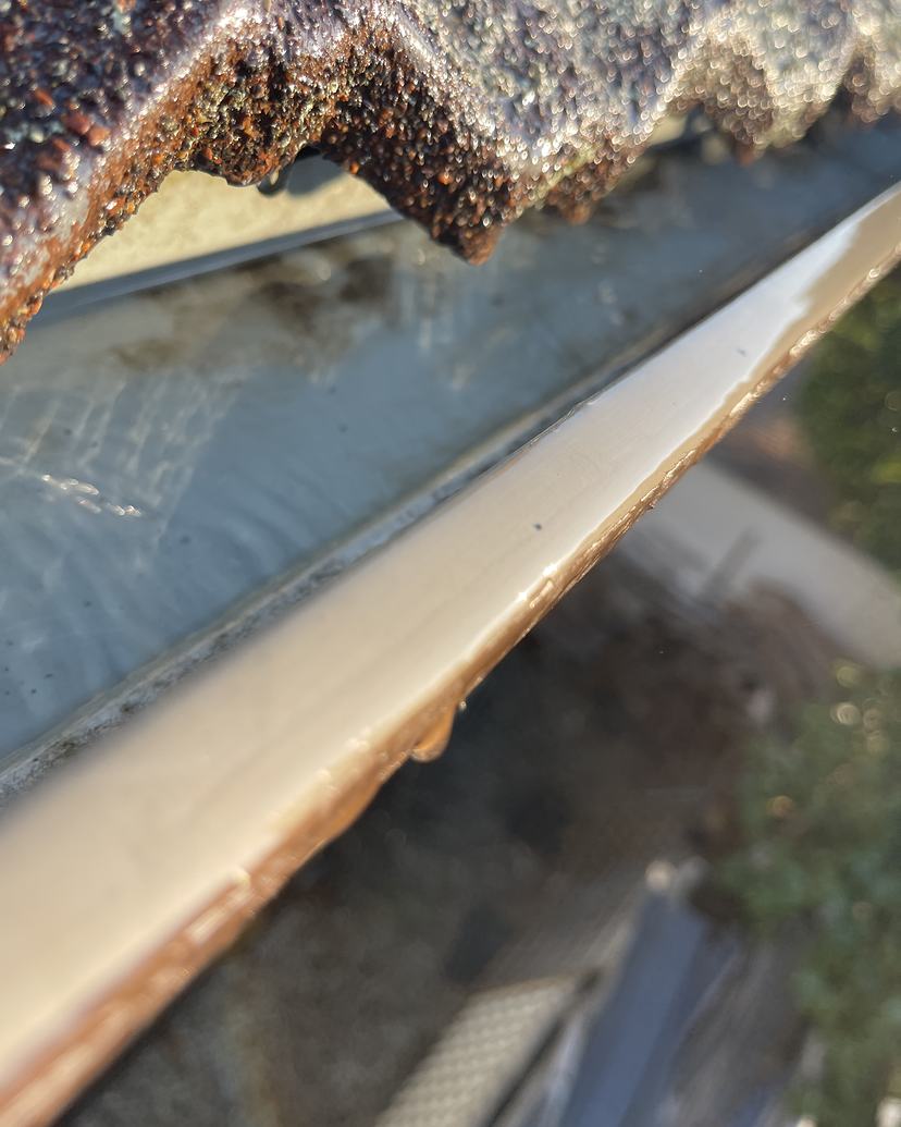 The same gutter after cleaning, clear to the metal
