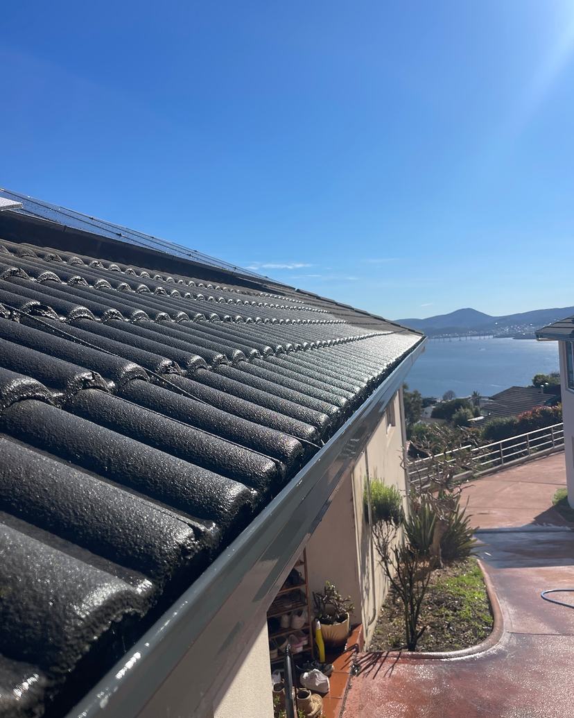 The same Sandy Bay gutter cleared, with the River Derwent behind
