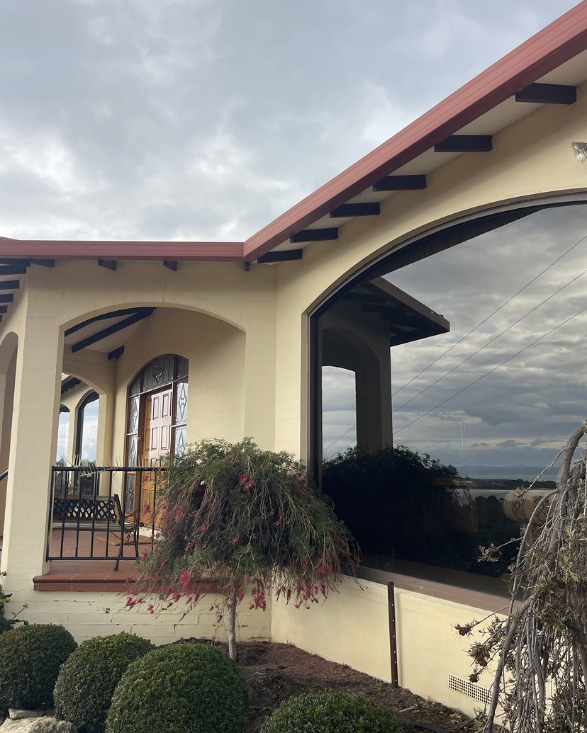 Rendered home with arched windows, glass clean and clear