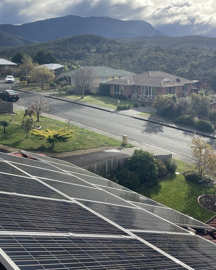 Clean solar panels with kunanyi / Mount Wellington in the background