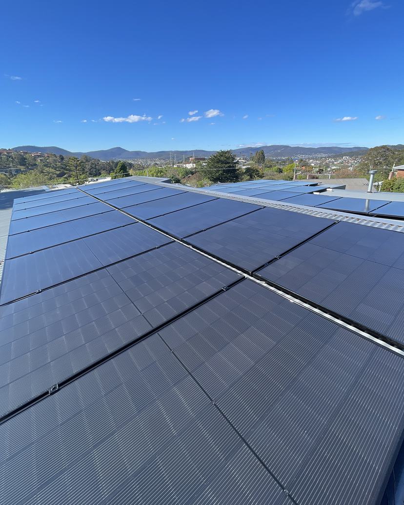 Clean solar panels in Lenah Valley with kunanyi / Mount Wellington behind