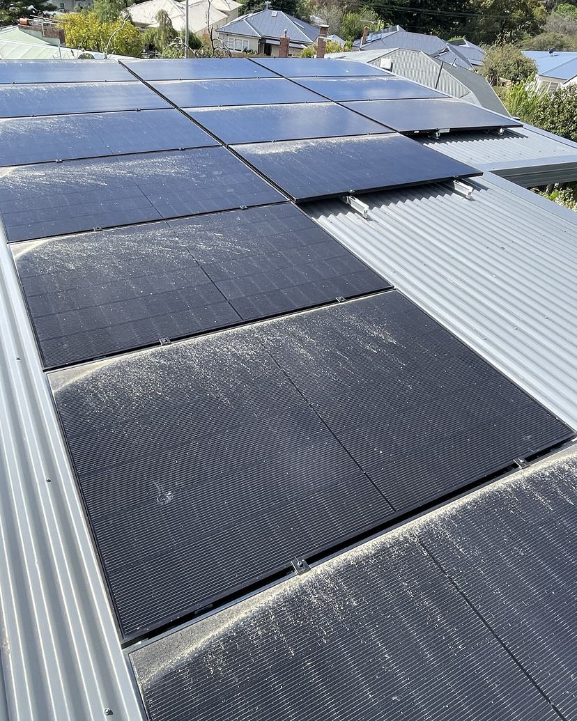 Dusty, marked solar panels on a Lenah Valley roof before cleaning