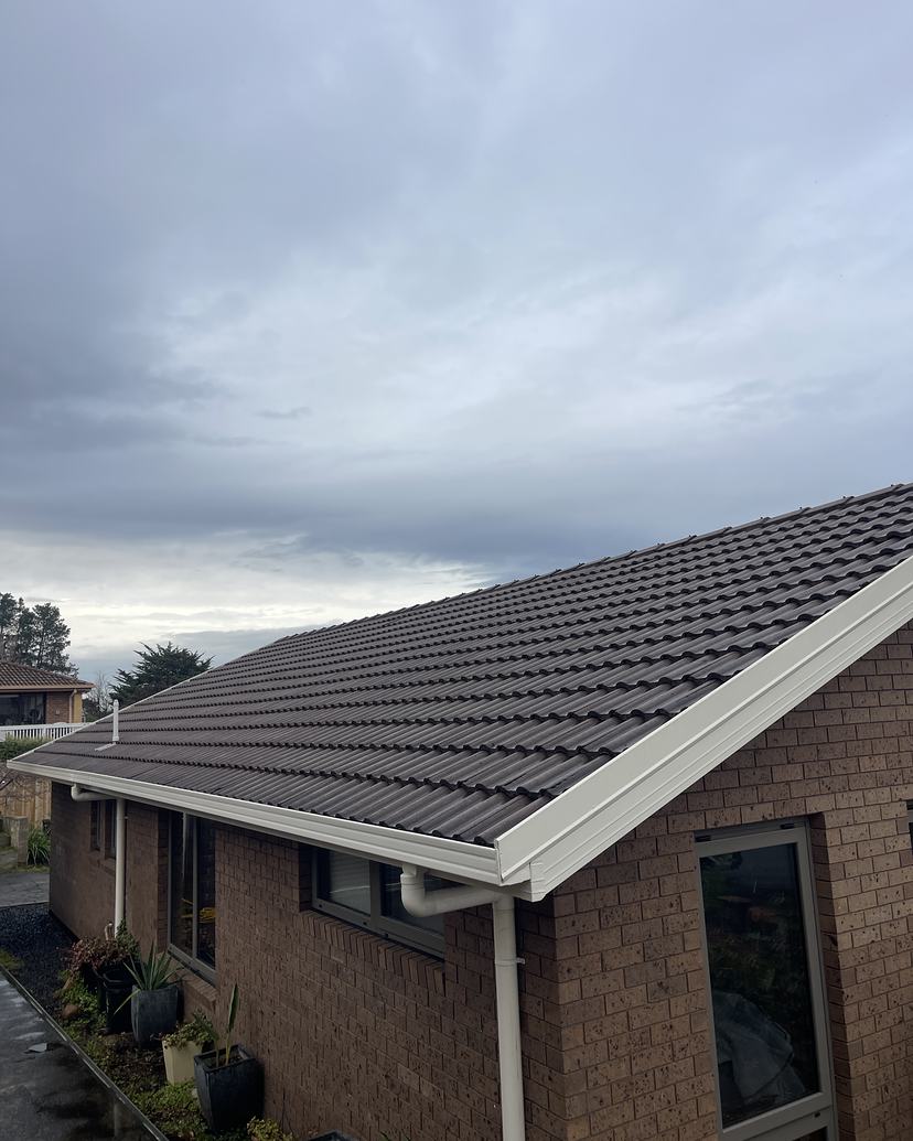 Brown tiled roof and white gutters in Blackmans Bay after roof cleaning