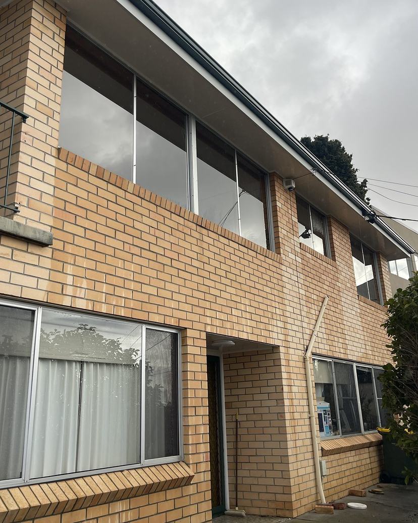 Two-storey brick home with freshly cleaned windows