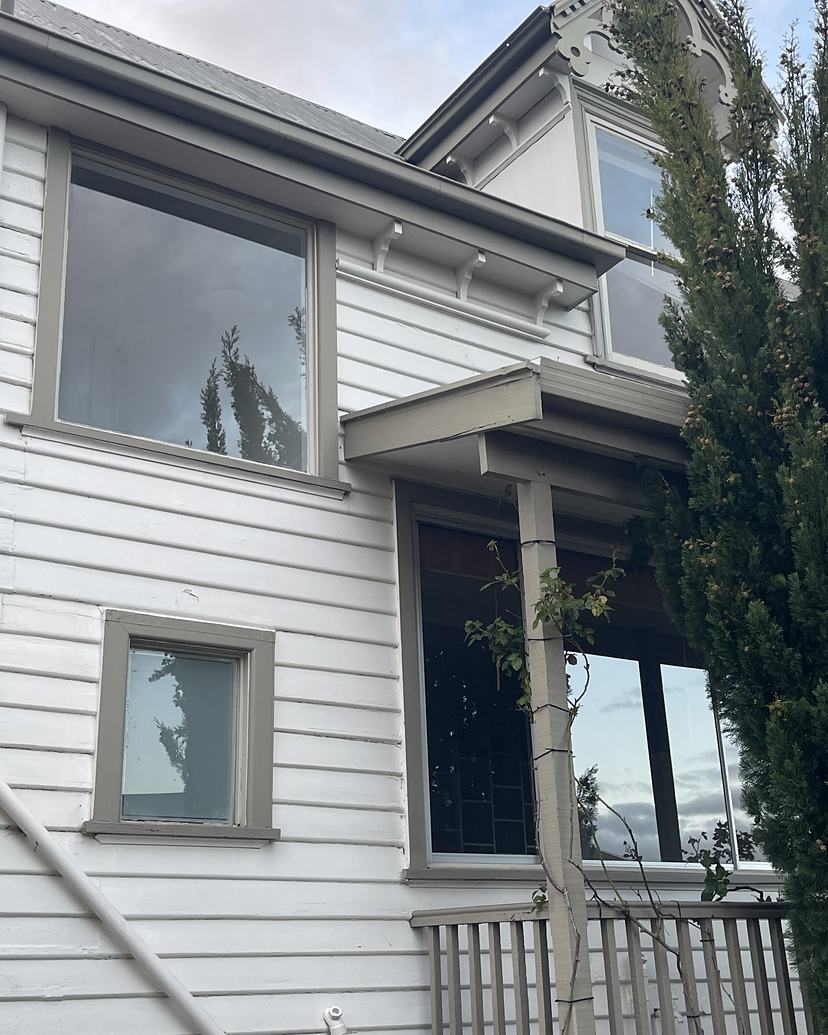 White weatherboard home in West Hobart with freshly cleaned windows